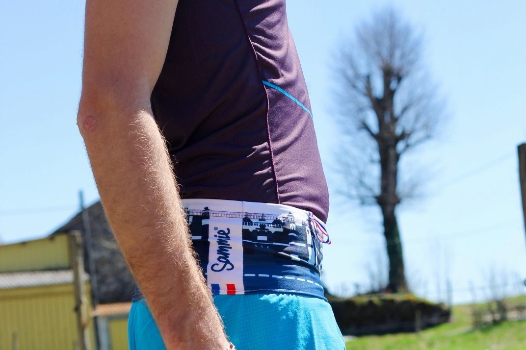 Un runner ouvre de la ceinture de Running Sammie® Mini pour récupérer un objet